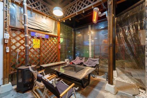 a room with a table and chairs in a building at Suncheon Slow Pension in Suncheon