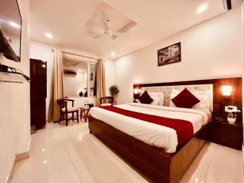 a bedroom with a large bed and a table and chairs at Sitara Economy The Pacific, Haridwar in Haridwār