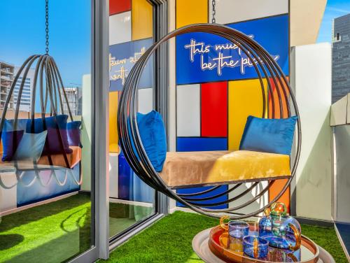 a room with a swing on a balcony at Modern High-Floor Apartment with Burj Khalifa View by Dejaview Stays in Dubai