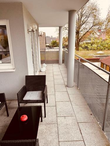 a balcony with a bench and a table on a building at Ferienwohnung Eichel in Rust
