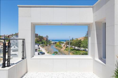 a large window in a building with a view of the ocean at Gangneung ST153 in Kyŏngp'o-mal