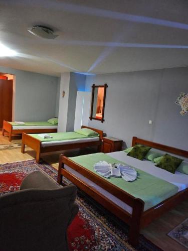 a bedroom with two beds and a couch and a mirror at Genex-M in Bugojno