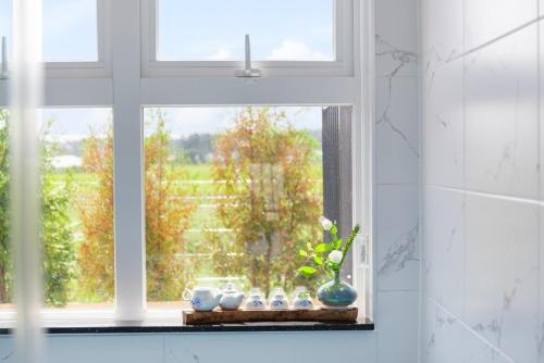 a window with a bunch of vases on a shelf at Gangneung Stay 302 in Hwapyeong-dong