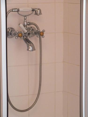 a shower with a shower head in a bathroom at Villa Žvejų 29 in Palanga