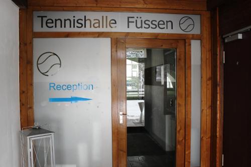 an entrance to a building with a sign on the door at Motel Füssen im Allgäu in Füssen