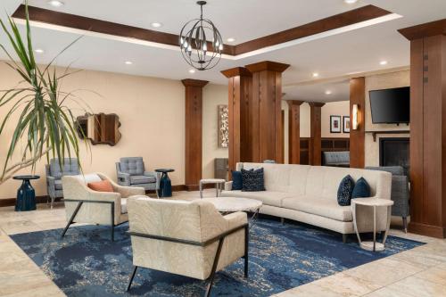 a living room with a couch and chairs at Homewood Suites by Hilton Newport-Middletown in Middletown