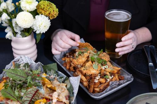 a person sitting at a table with food and a glass of beer at Halifax Marriott Harbourfront Hotel in Halifax