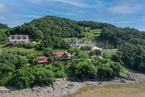 an aerial view of a house on a hill at Badawiae Tongnamu Pension in Yeosu