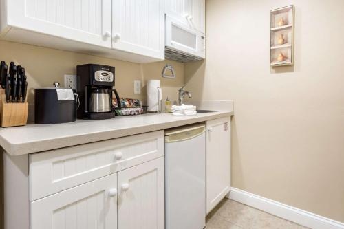 a kitchen with white cabinets and a counter top at Bluegreen Vacations The Breakers Resort, an Ascend Collection Resort in Dennis Port