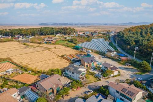 an aerial view of a small village with a field at Daebudo Siesta Pension in Ansan