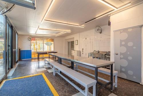 a room with a table and benches in it at Daebudo Siesta Pension in Ansan