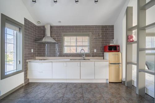 a kitchen with a sink and a refrigerator at Saint in Udumji Pool Villa in Sanjeong-ri