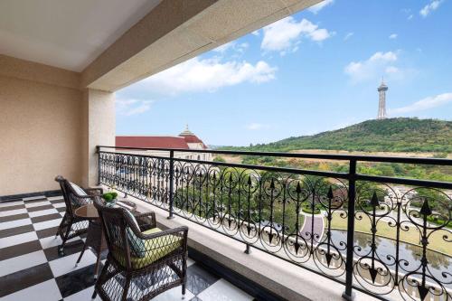 a balcony with chairs and a view of a lighthouse at Wyndham Taian West in Tai'an