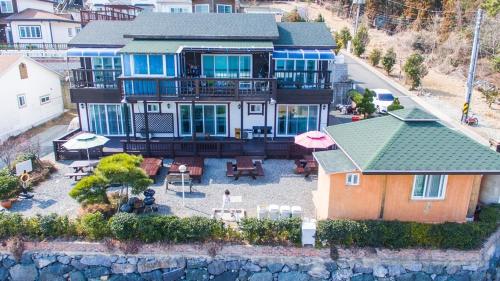 an aerial view of a large house with a patio at Geoje Sky Terrace Pension in P'allangp'o