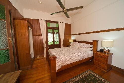 a bedroom with a bed and a ceiling fan at The Village B&B in Gold Coast