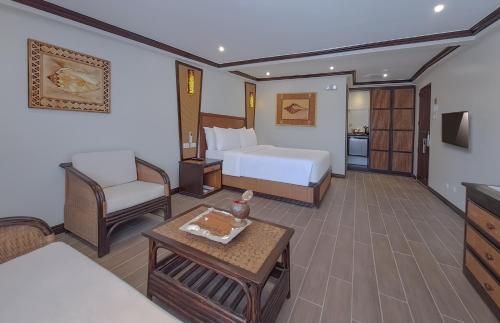 a hotel room with a bed and a table at Red Coconut Beach Hotel Boracay in Boracay