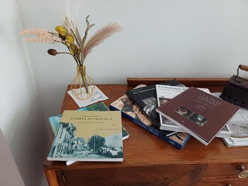 a table with books and a vase of flowers at Villa MARGHERITA in Pratola Peligna