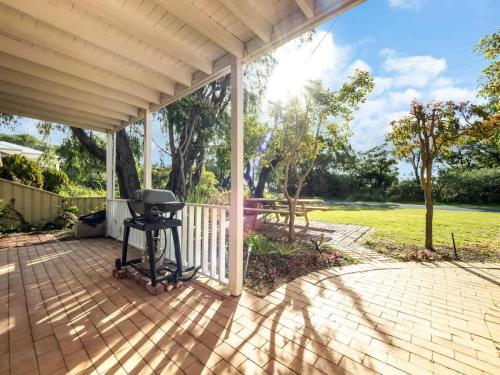 a patio with a barbecue grill on it at Beachfront Bliss, waterfront Geographe bay in Busselton