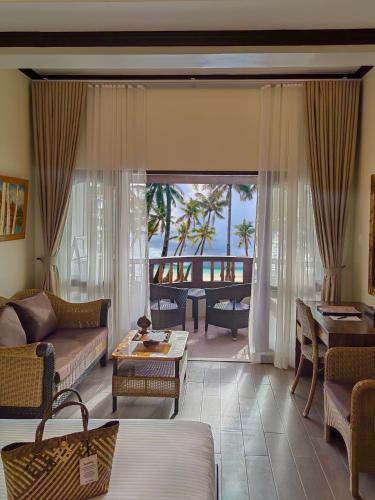 a living room with a view of the ocean at Red Coconut Beach Hotel Boracay in Boracay