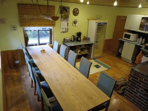 a dining room with a wooden table and chairs at Paepealse Guesthouse in Kullamaa