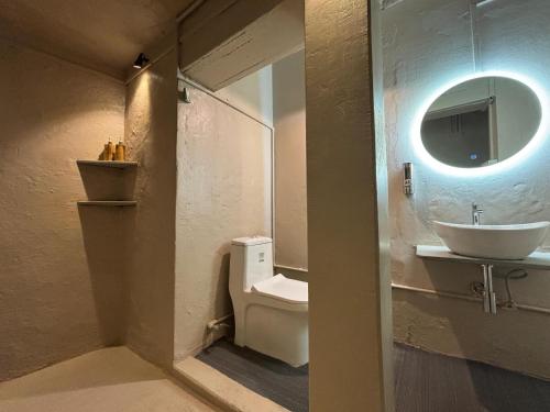 a bathroom with a toilet and a sink and a mirror at Vintage River Homestay in Varanasi