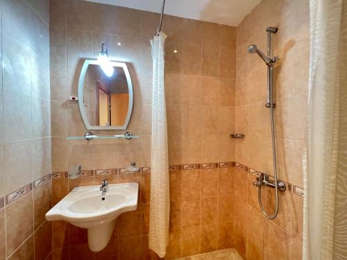a bathroom with a sink and a shower and a mirror at Александра in Sveti Vlas