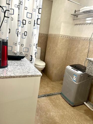 a bathroom with a toilet and a shower curtain at Blue Sea 01 Hotel in Nha Trang