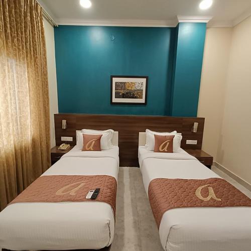 Ένα ή περισσότερα κρεβάτια σε δωμάτιο στο ASTRA HOTELS & SUITES WHITEFIELD NEAR NALLURAHALLI METRO STATION and KTPO