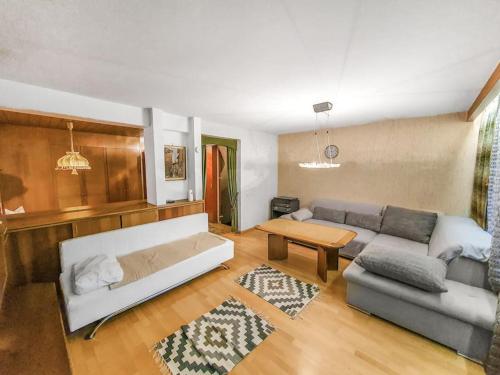 a living room with a couch and a table at Gemütliches Terrassenhaus in Degerfelden