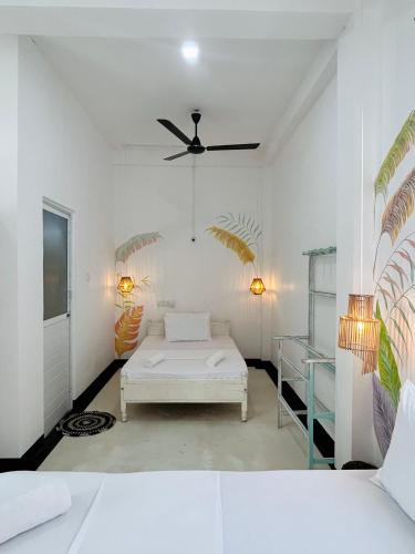 a bedroom with a bed and a ceiling fan at Gypsea' Madiha in Matara