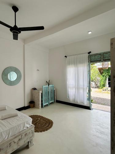 a bedroom with a bed and a sliding glass door at Gypsea' Madiha in Matara
