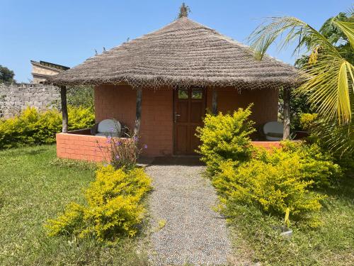 a small house with a thatch roof at Alhasia Ecoville Jambur Gambia in Jambur