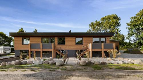 a house with a black roof at Bali -Habernis, direkt an der Ostsee in Steinberg