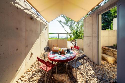 a patio with a table and chairs in a building at Dalto Resort Poolvilla Glamping in Yeongdeok