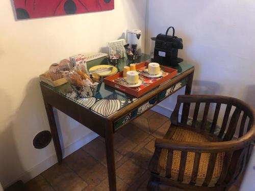 a glass table with food on it with a chair at B&B Villa la Canonica con piscina a Padernello in Farfengo