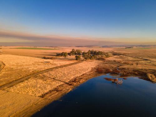 an aerial view of a body of water in the desert at Dalmore Guest Farm in Bergville