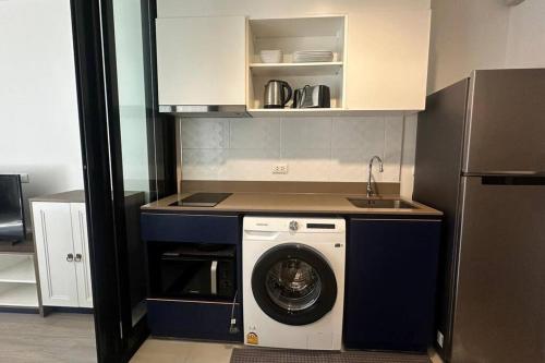 a kitchen with a washing machine and a sink at The Base Central Phuket-C4YW in Phuket