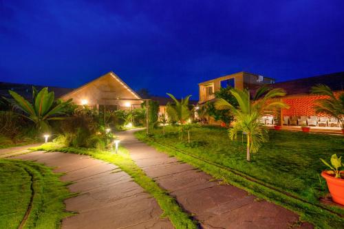 a walkway in front of a house at night at Sterling Orient Woods Pench in Silāri