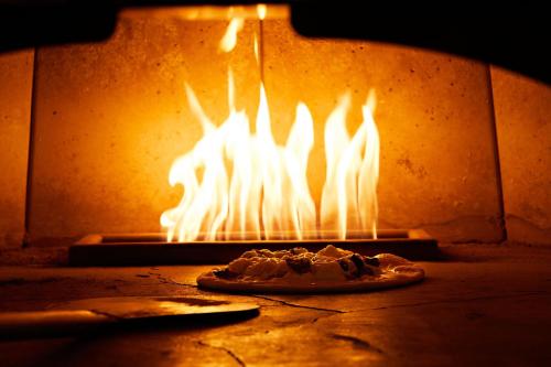 a pizza in a brick oven with fire in it at Marriott Bethesda Downtown at Marriott HQ in Bethesda
