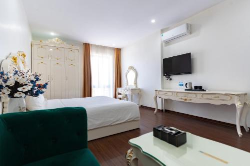 a hotel room with a bed and a desk at Grand Hill Hotel & Apartment in Hai Phong