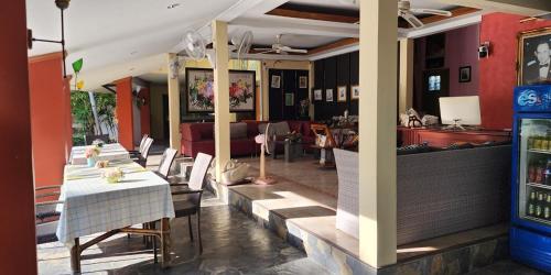 a restaurant with a table and chairs in a room at Safari Riviera Resort in North Pattaya