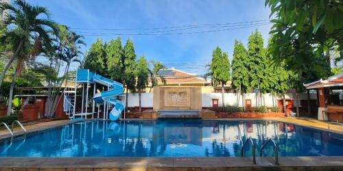 a large swimming pool with a blue slide at Safari Riviera Resort in North Pattaya