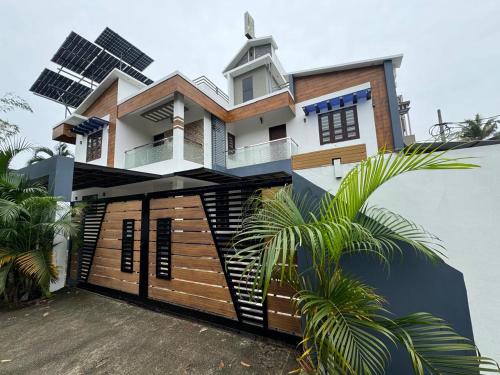 a house with solar panels on the side of it at Venice Rosedale in Alleppey