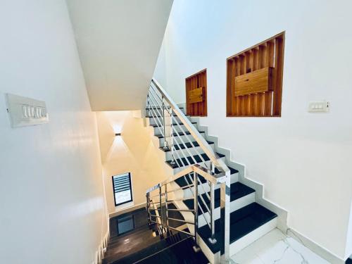 a staircase in a house with blue stairs at Venice Rosedale in Alleppey