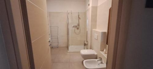 a bathroom with a shower and a toilet and a sink at Foresteria Emilia in Grosotto
