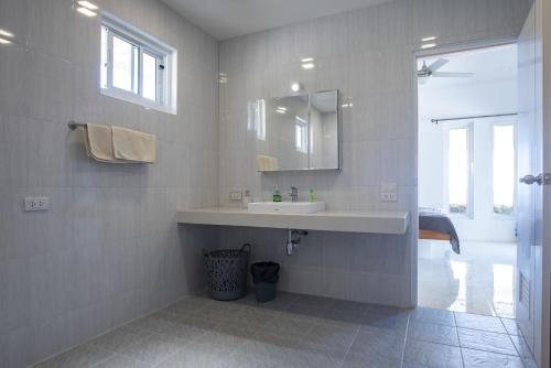 a bathroom with a sink and a mirror at Corsita Resort Koh Mak in Ko Mak