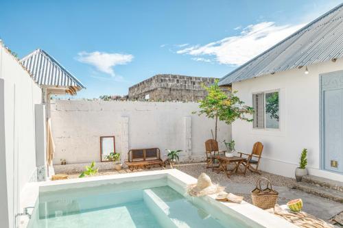 a backyard with a swimming pool and a house at Zanzibar Halisi holiday home, by Liv Zanzibar in Paje