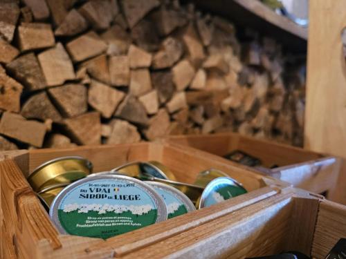 a wooden box with chocolates in front of a fireplace at Trail-Inn Natur & Sporthotel in Berdorf