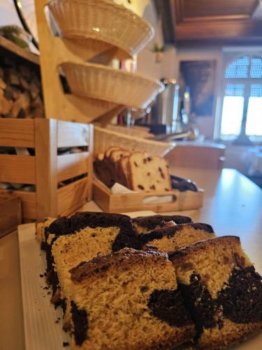 a loaf of bread sitting on a counter with a cutting board at Trail-Inn Natur & Sporthotel in Berdorf