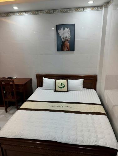 a bedroom with a large bed with a pillow on it at Kiều Tiên Hotel in Long Thành